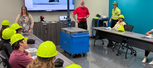 TekStarz campers wearing hard hats and listening to person talk from BEST Manufacturing in Jonesboro