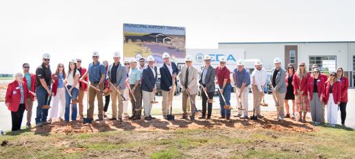 Officials, partners and supporters standing with shovels full of dirt in the groundbreaking for the Jonesboro Municipal Airport Commercial Terminal
